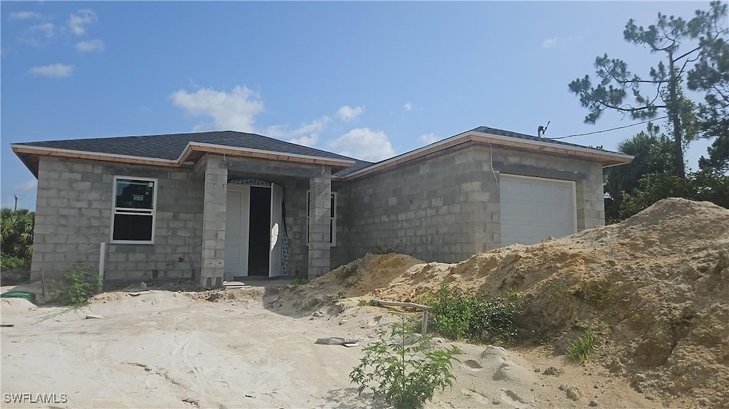 2505 15th St W, Lehigh Acres, FL 33971 - view of front of home with a garage and concrete block siding