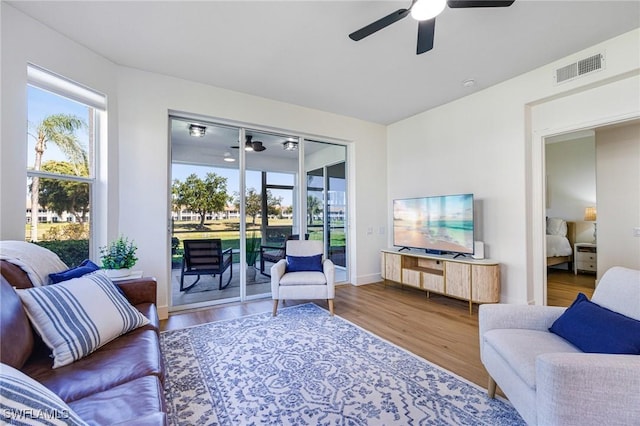16451 Millstone Cir Unit 101, Fort Myers, FL 33908 - living area with ceiling fan, wood finished floors, and baseboards