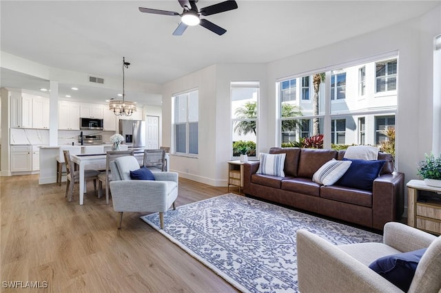 16451 Millstone Cir Unit 101, Fort Myers, FL 33908 - living area featuring a chandelier, ceiling fan, baseboards, light wood-type flooring, and recessed lighting
