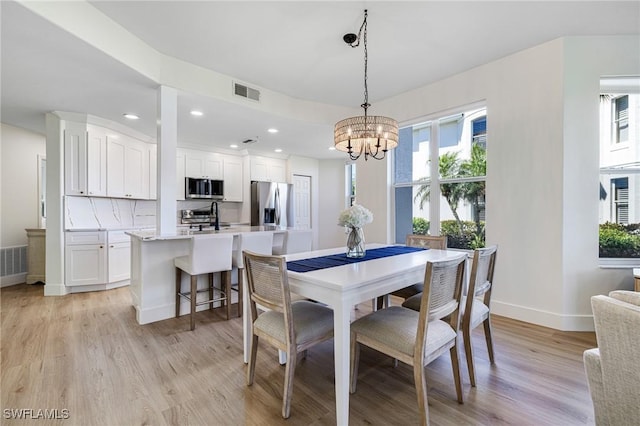 16451 Millstone Cir Unit 101, Fort Myers, FL 33908 - dining room featuring plenty of natural light, light wood-type flooring, baseboards, a chandelier, and recessed lighting
