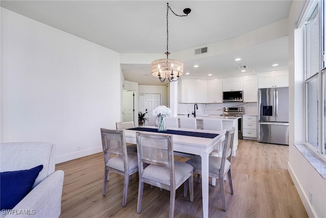 16451 Millstone Cir Unit 101, Fort Myers, FL 33908 - dining room with a chandelier, light wood-type flooring, baseboards, and recessed lighting