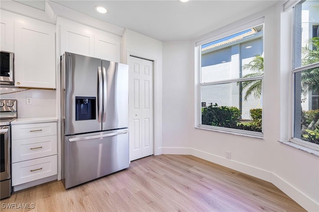16451 Millstone Cir Unit 101, Fort Myers, FL 33908 - kitchen featuring stainless steel appliances, white cabinetry, light wood-style flooring, and recessed lighting