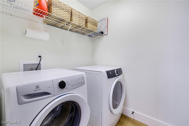 16451 Millstone Cir Unit 101, Fort Myers, FL 33908 - laundry room featuring washing machine and dryer, baseboards, and light wood-style floors