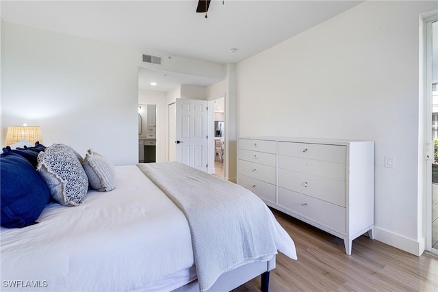16451 Millstone Cir Unit 101, Fort Myers, FL 33908 - bedroom with wood finished floors, baseboards, connected bathroom, and ceiling fan