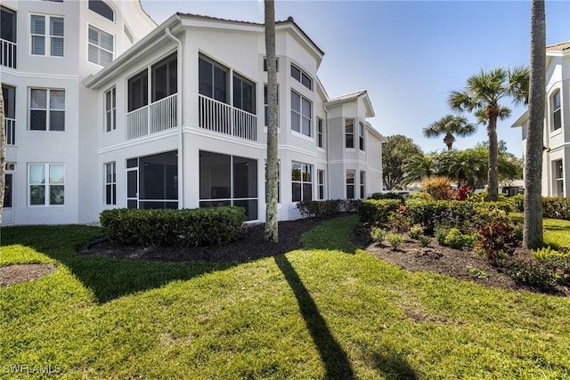 16451 Millstone Cir Unit 101, Fort Myers, FL 33908 - back of house featuring stucco siding and a lawn