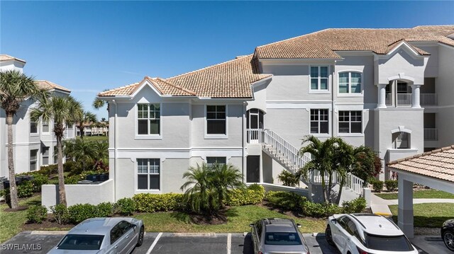 16451 Millstone Cir Unit 101, Fort Myers, FL 33908 - view of building exterior featuring uncovered parking