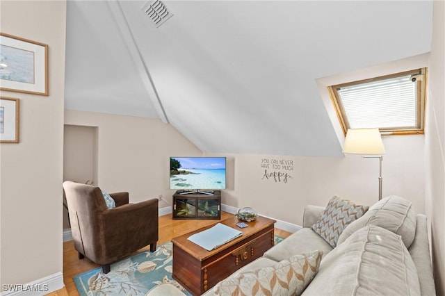 319 Nature View Ct, Fort Myers Beach, FL 33931 - living area featuring vaulted ceiling, wood finished floors, and baseboards