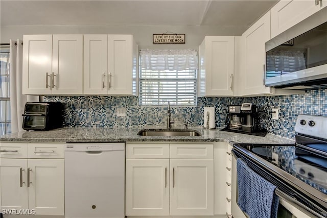 2303 NE 7th Ave, Cape Coral, FL 33909 - kitchen with white cabinets, appliances with stainless steel finishes, and a sink