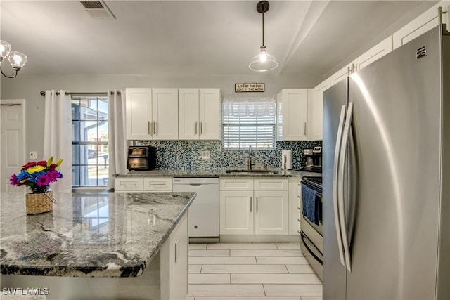 2303 NE 7th Ave, Cape Coral, FL 33909 - kitchen featuring range with electric cooktop, dishwasher, visible vents, a sink, and freestanding refrigerator