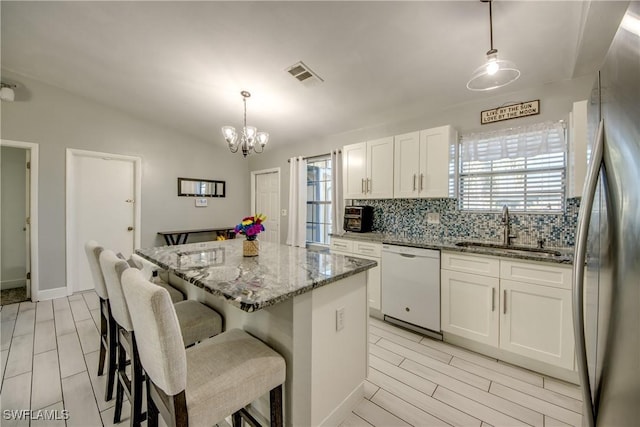 2303 NE 7th Ave, Cape Coral, FL 33909 - kitchen featuring a sink, tasteful backsplash, freestanding refrigerator, light stone countertops, and dishwasher