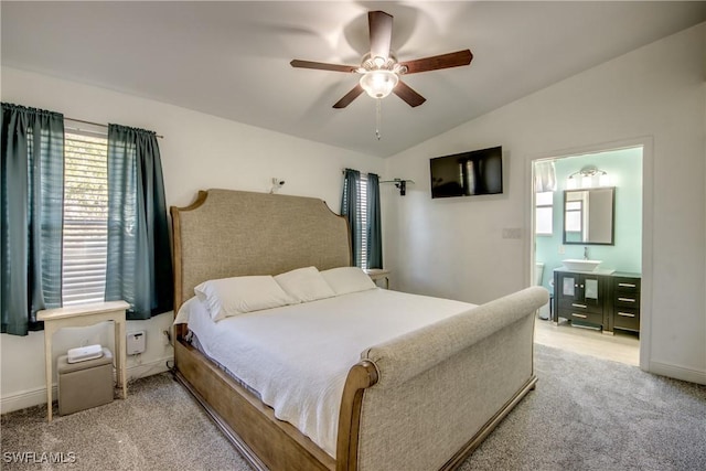 2303 NE 7th Ave, Cape Coral, FL 33909 - bedroom with vaulted ceiling, ensuite bath, baseboards, light colored carpet, and ceiling fan