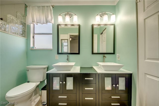 2303 NE 7th Ave, Cape Coral, FL 33909 - full bath featuring double vanity, toilet, ornamental molding, and a sink