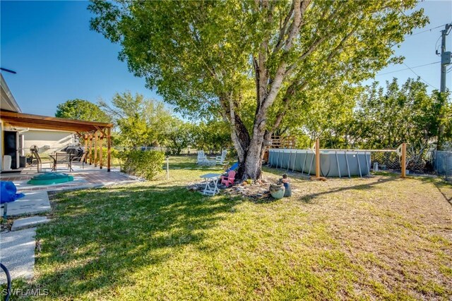 2303 NE 7th Ave, Cape Coral, FL 33909 - view of yard featuring a fenced backyard, a pool, and a patio