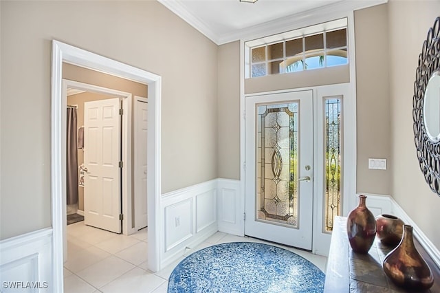 9078 Shadow Glen Way, Fort Myers, FL 33913 - foyer featuring crown molding, wainscoting, plenty of natural light, a decorative wall, and light tile patterned floors