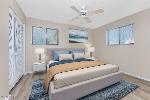 801 Islamorada Blvd Unit 21A, Punta Gorda, FL 33955 - bedroom featuring a closet, light wood-style floors, multiple windows, and baseboards