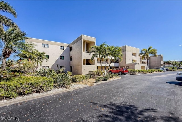 801 Islamorada Blvd Unit 21A, Punta Gorda, FL 33955 - view of building exterior with uncovered parking and a residential view