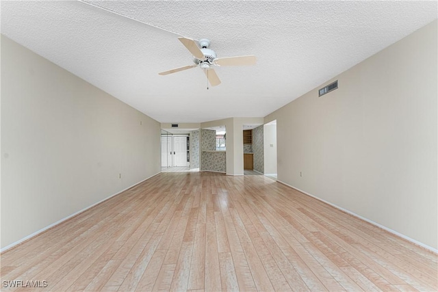 801 Islamorada Blvd Unit 21A, Punta Gorda, FL 33955 - unfurnished living room with light wood-style flooring, a ceiling fan, and baseboards