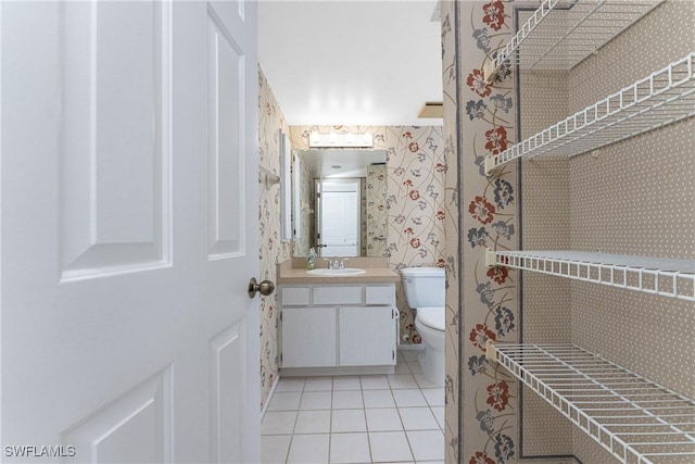 801 Islamorada Blvd Unit 21A, Punta Gorda, FL 33955 - half bath with wallpapered walls, vanity, tile patterned floors, and toilet
