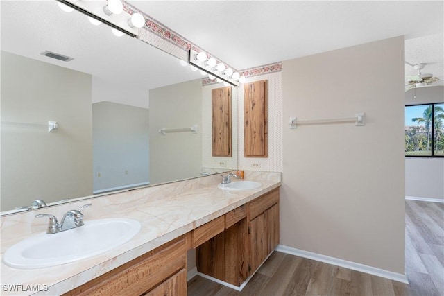 801 Islamorada Blvd Unit 21A, Punta Gorda, FL 33955 - bathroom with wood finished floors, double vanity, ceiling fan, and baseboards