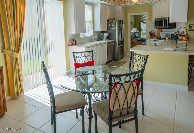 dining area with light tile patterned floors