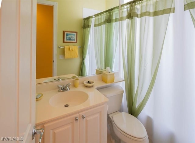 full bath featuring toilet and vanity