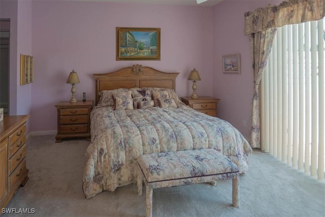 bedroom featuring light colored carpet