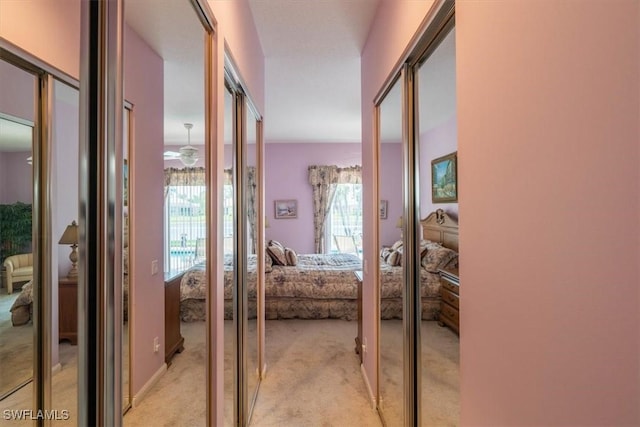 hallway with french doors and light carpet