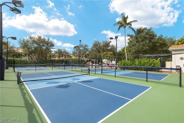 view of sport court featuring fence