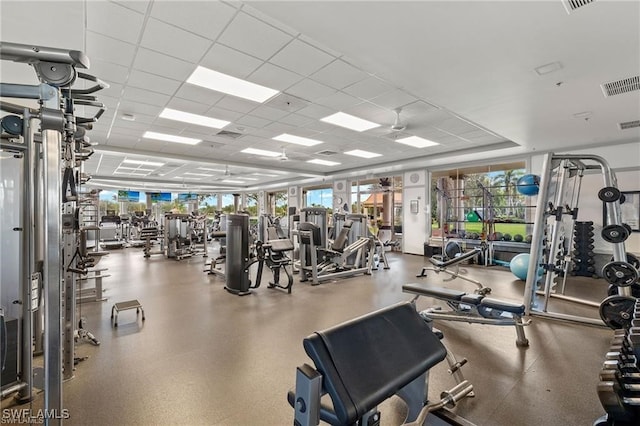 gym with a paneled ceiling and visible vents