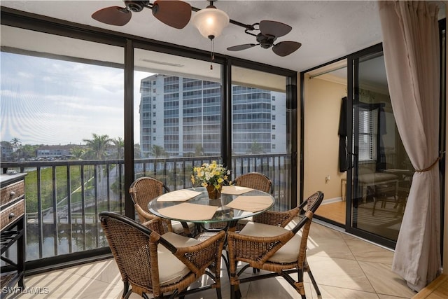 interior space with light tile patterned flooring, floor to ceiling windows, and a ceiling fan