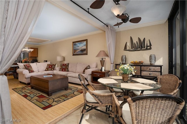 living room featuring ornamental molding, wood finished floors, and ceiling fan with notable chandelier