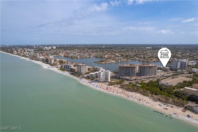birds eye view of property with a water view, a view of the beach, and a city view