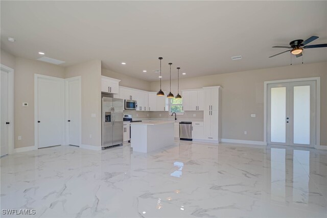 kitchen with open floor plan, recessed lighting, appliances with stainless steel finishes, and a kitchen island