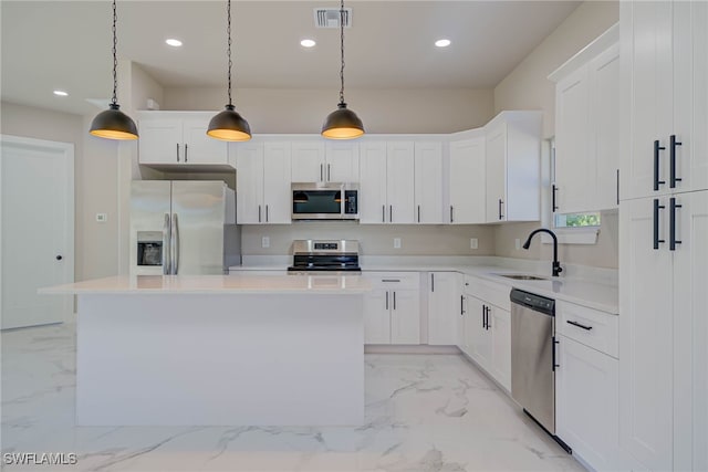 kitchen with stainless steel appliances, a center island, marble finish floor, a sink, and visible vents