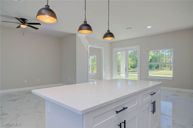 kitchen featuring pendant lighting, marble finish floor, baseboards, visible vents, and recessed lighting