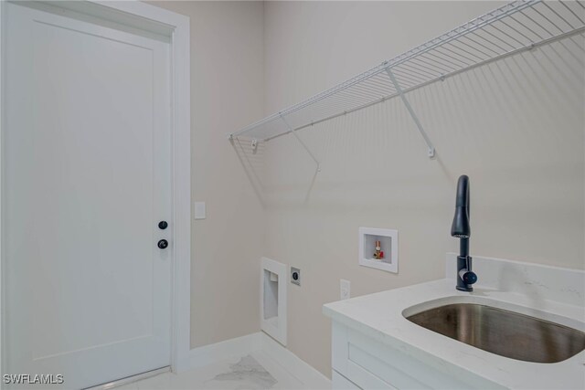 laundry room featuring hookup for a washing machine, marble finish floor, laundry area, a sink, and electric dryer hookup