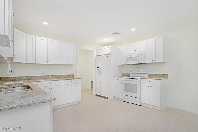 1861 Lillie St, Fort Myers, FL 33916 - kitchen with white cabinets, visible vents, white appliances, a sink, and light stone counters
