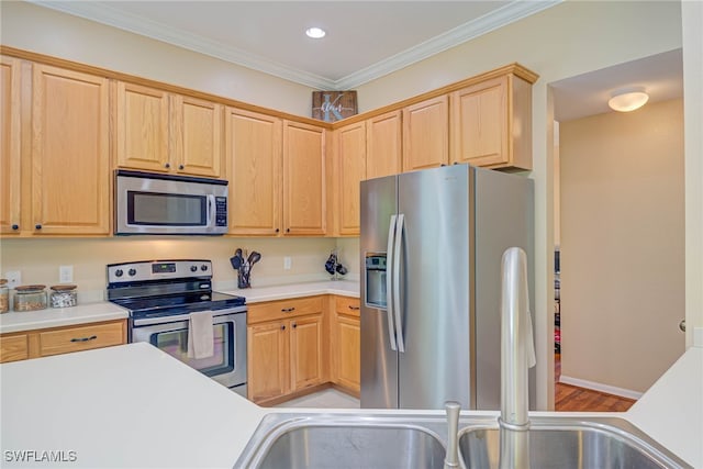kitchen featuring crown molding, light brown cabinetry, recessed lighting, light countertops, and appliances with stainless steel finishes