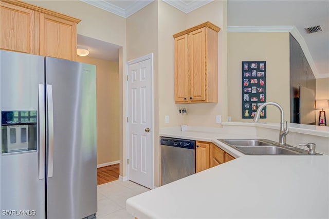 kitchen featuring light brown cabinetry, appliances with stainless steel finishes, crown molding, and a sink