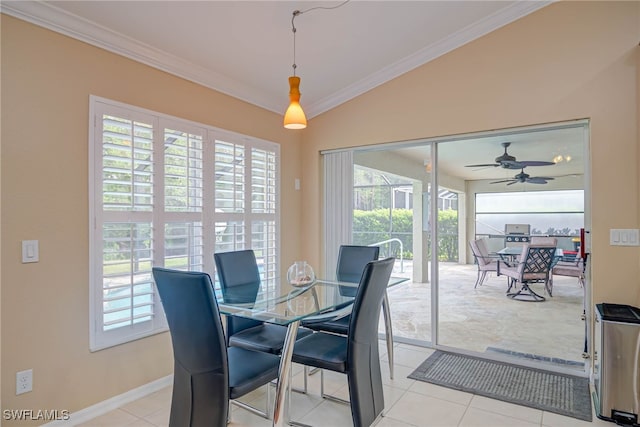 dining area with crown molding, baseboards, light tile patterned floors, and a wealth of natural light