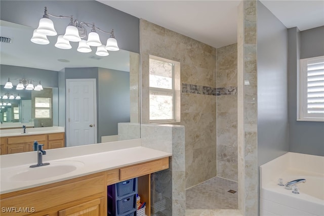 full bathroom with vanity, a bath, visible vents, and tiled shower