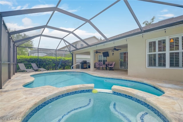 view of swimming pool with a pool with connected hot tub, a patio, ceiling fan, a lanai, and a grill