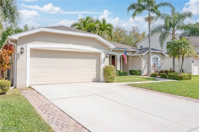 ranch-style house with stucco siding, an attached garage, driveway, and a front yard