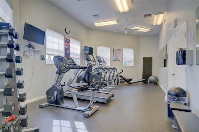 workout area featuring baseboards, ceiling fan, and visible vents