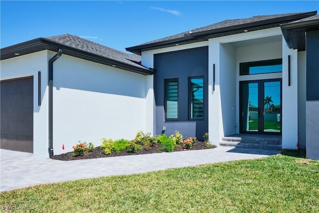 view of property exterior featuring french doors, an attached garage, stucco siding, and a lawn