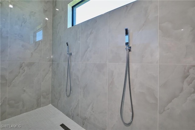 full bath with a tile shower
