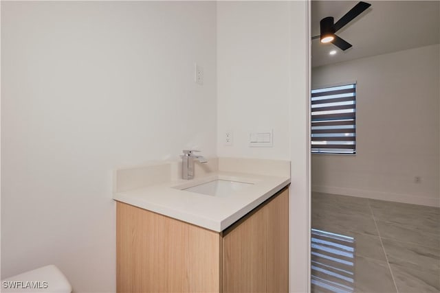 bathroom featuring toilet, a ceiling fan, and vanity
