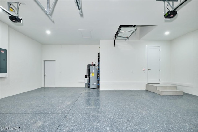 garage featuring electric panel, electric water heater, recessed lighting, and a garage door opener