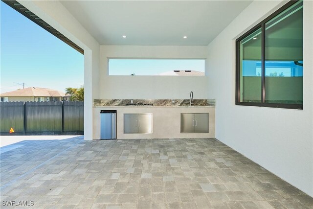 view of patio / terrace featuring a sink, area for grilling, and fence