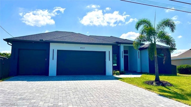 ranch-style house with stucco siding, decorative driveway, a front yard, and a garage